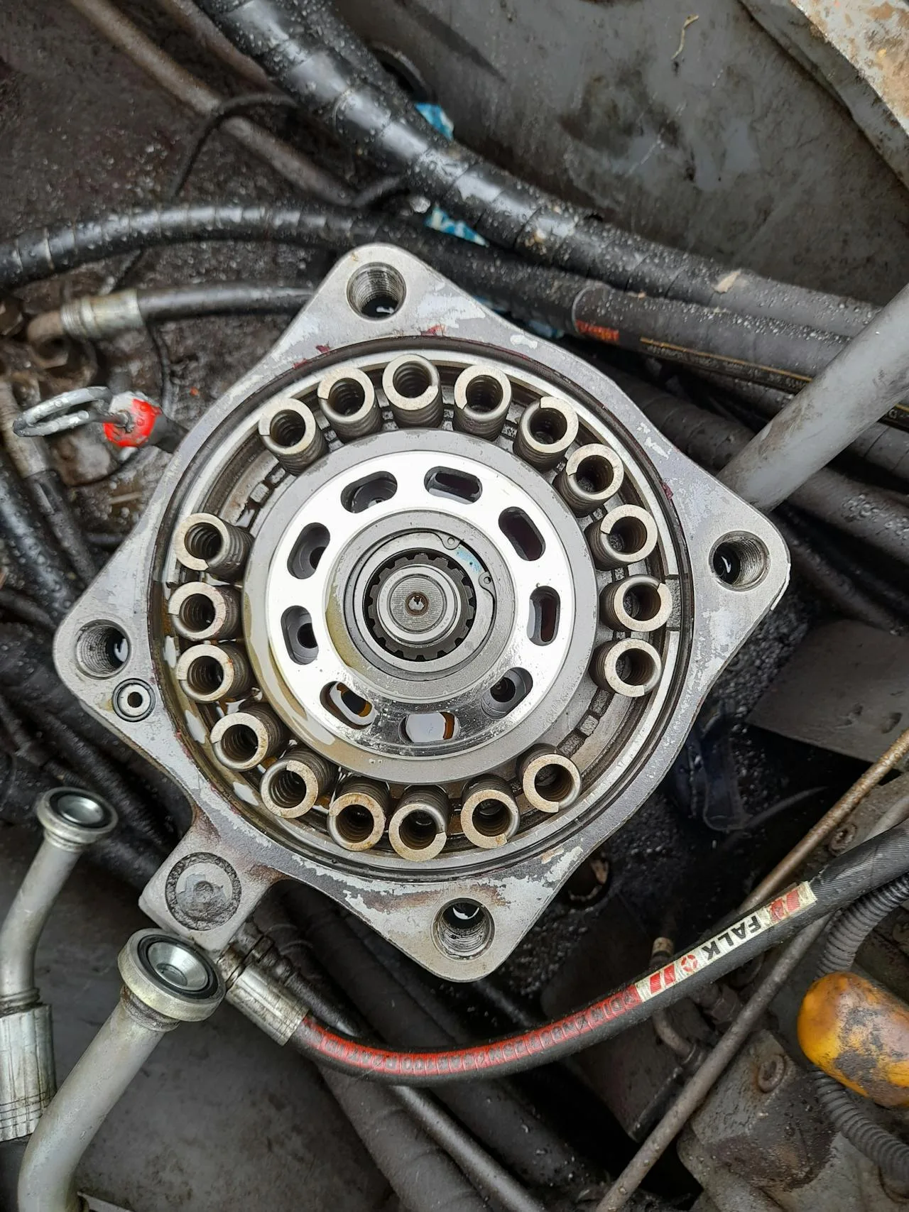 Close-up view of hydraulic hose crimping process showing die compression on metal ferrule